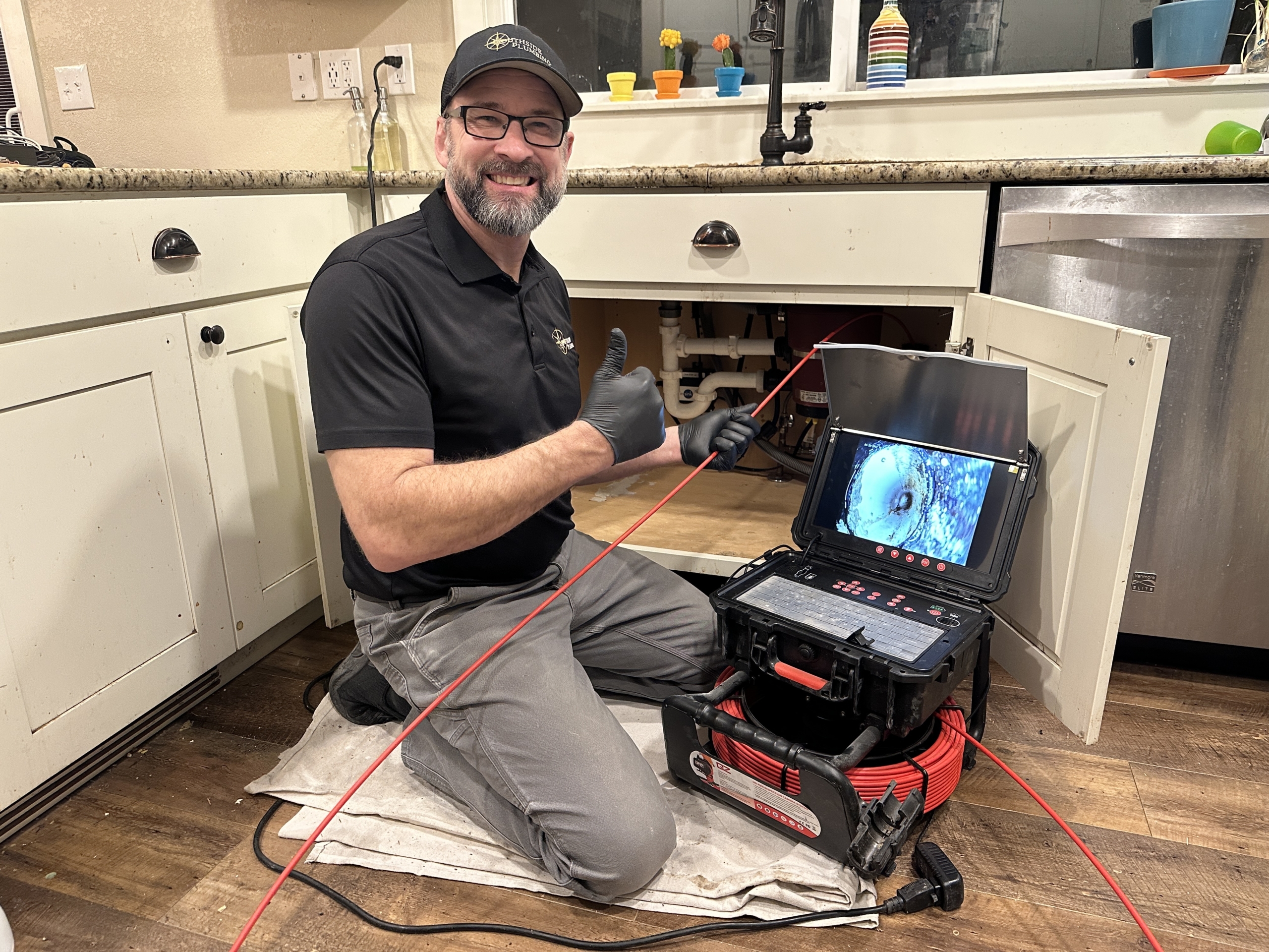Southside Plumbing owner, Mark Friesen, scoping a drain.